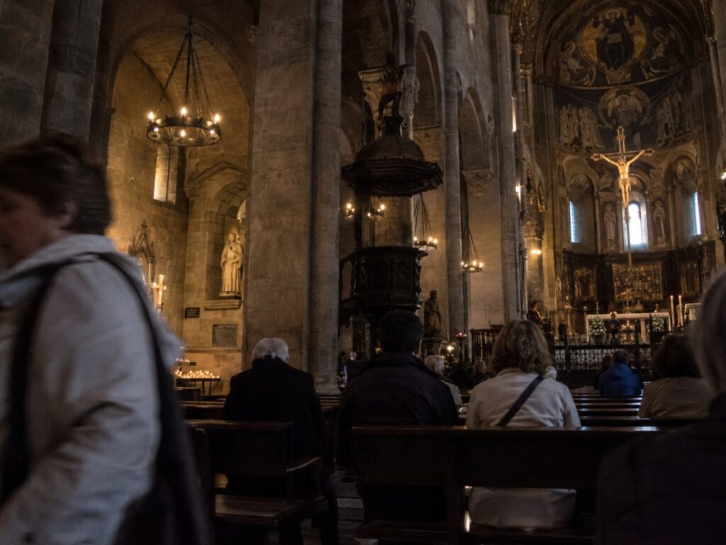 Inside the basilica: frescoes above the altar and a carved wooden pulpit